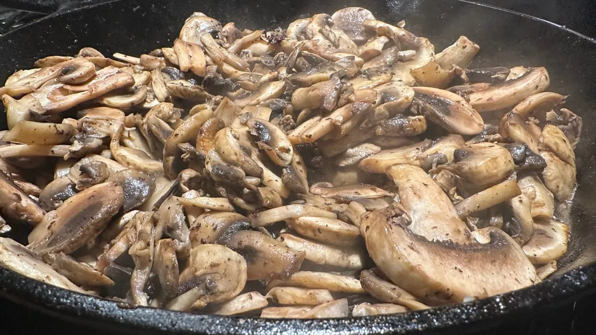 Mushrooms cooked down to gold and brown in the cast iron skillet